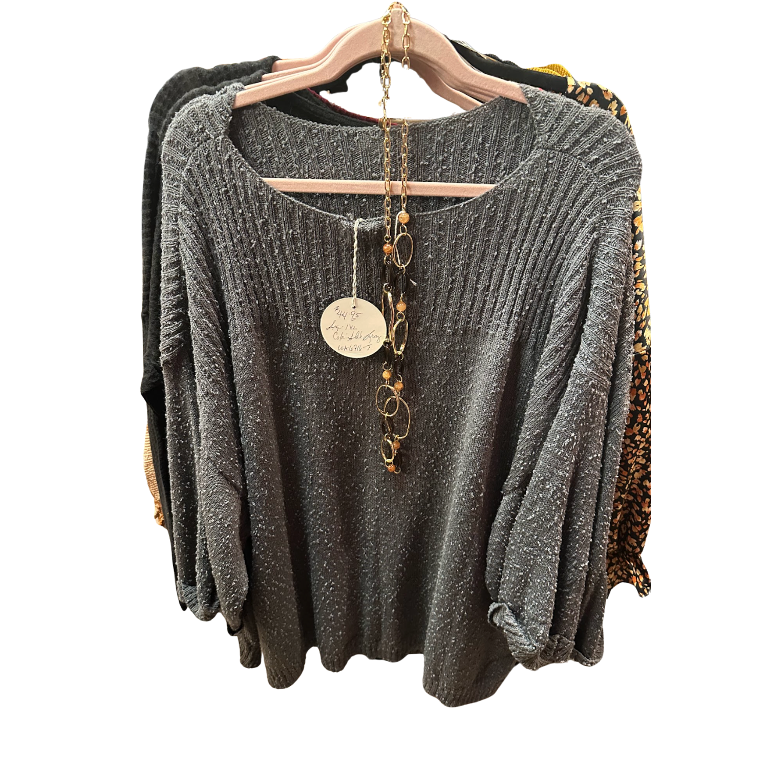 Umgee Flowy Long-Sleeve Wideneck Shirt hanging on a rack at Merle Norman Elizabethton. 