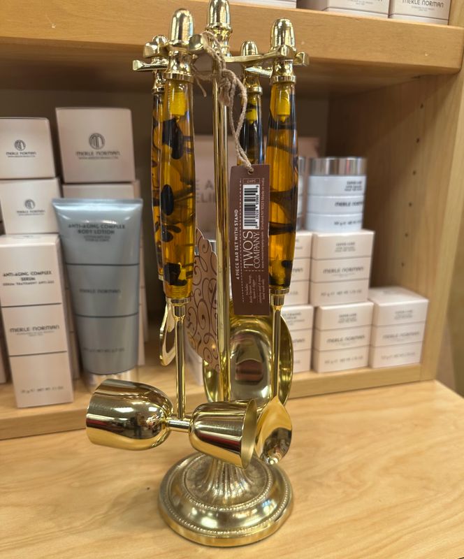 Two's Company 4 Pc Tortoise Print Bar Set with Stand sitting on a counter at Merle Norman Elizabethton. 