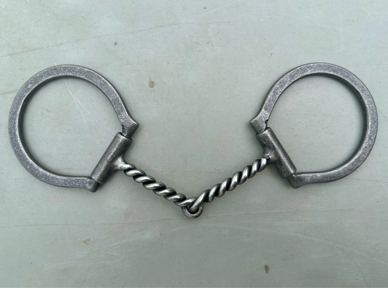 Dee Ring Snaffle Bit with 3 1/2” Sleeved Dee Rings and 5 1/8” Twisted Mouth Piece in Gun Metal Gray Brushed Steel