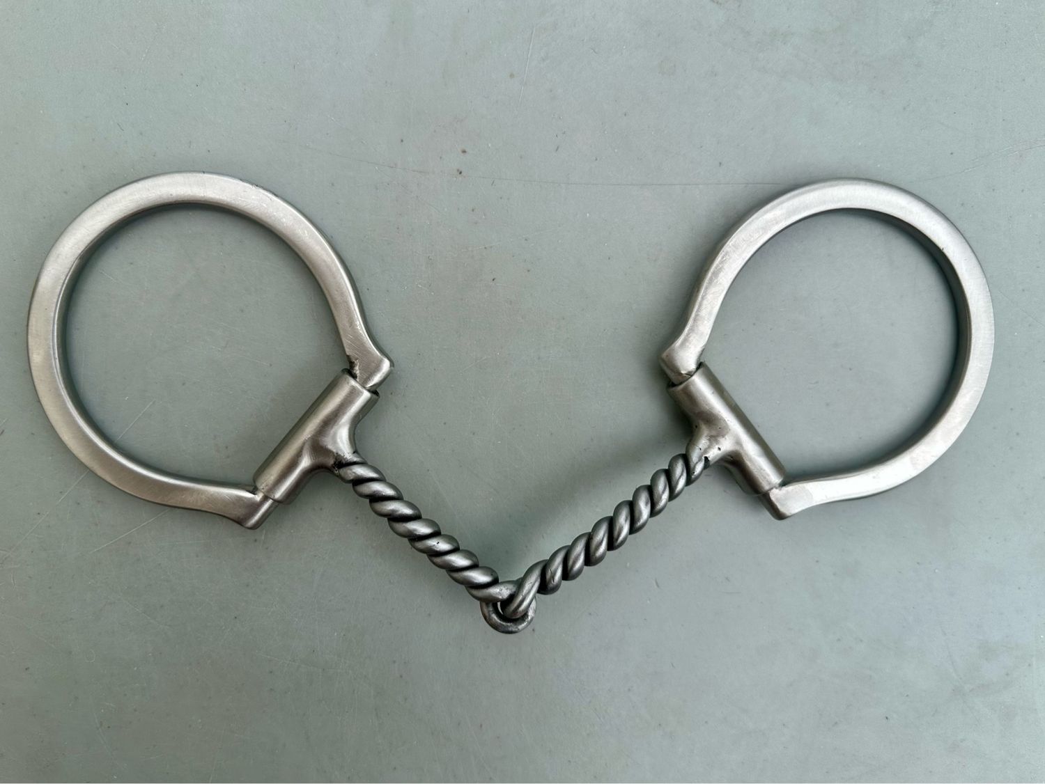 Dee Ring Snaffle Bit with 3 1/2” Sleeved Dee Rings and 5 1/8” Twisted Mouth Piece in Brushed Stainless Steel