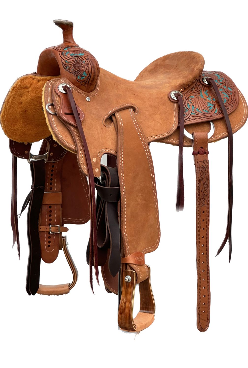 Robert Teskey Elite Ranch Roping Saddle with a 15- inch Rough Out Seat in Medium Oil Finish Poinsettia on Turquoise Background 060425