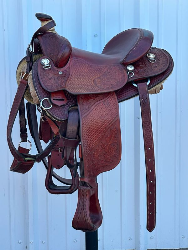 C. L. Long Hershey, CO Mule Saddle with a 15- inch Slick Out Seat Basket Weave and Oak Leave Tooled with Matching Breast Collar