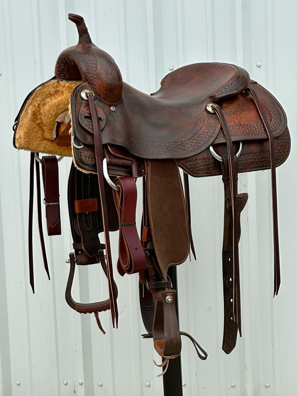 Roohide Saddlery Cutting Horse Saddle with a 16 1/2- inch Slick Out Seat Tooled with Border Basket Weave Dark Finish