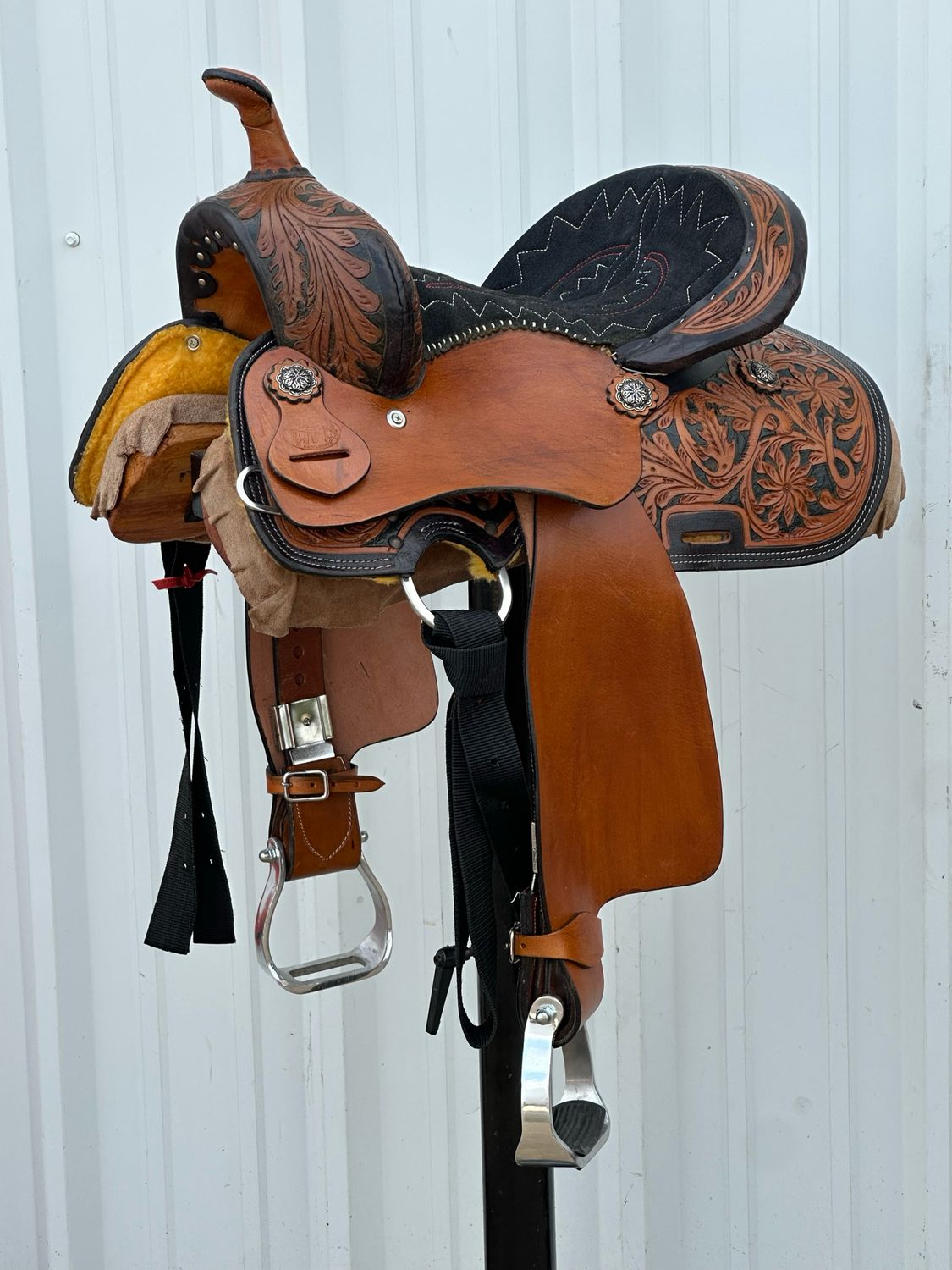 Chisom Trail Kid’s Saddle with a 12 1/2- inch Padded Black Red and White Stitched Seat Tooled Floral with Berry Conchos