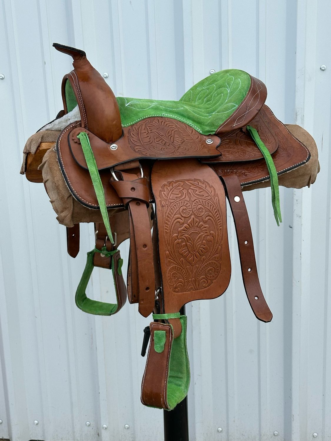 Pony Saddle with a 12- inch Green Stitched Padded Seat Tooled Foliage