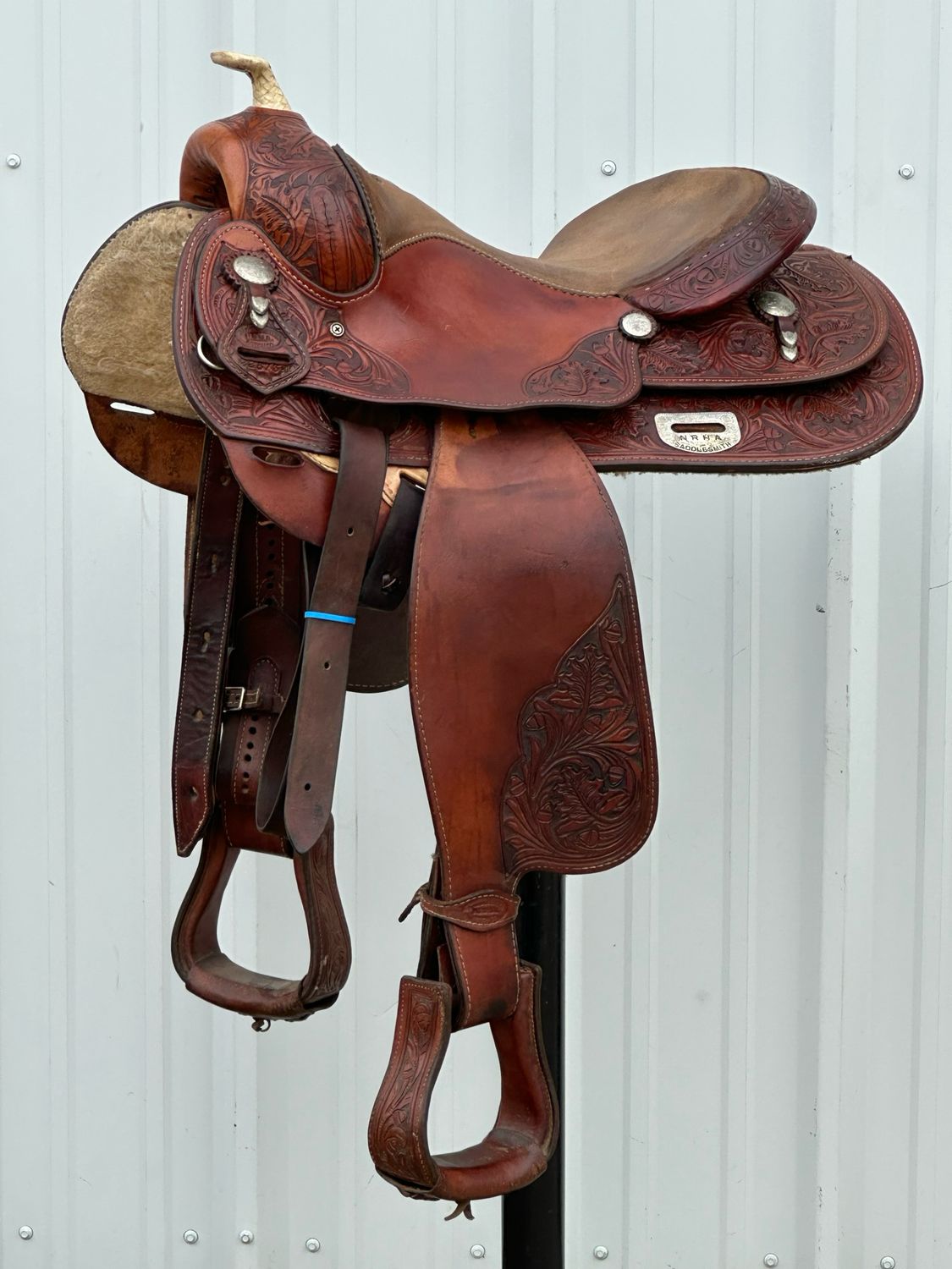N.R.H.A. Saddlesmith Reining Saddle with a 16- inch Padded Rough Out Seat Tooled Oak with Oak Leave Medium Finish