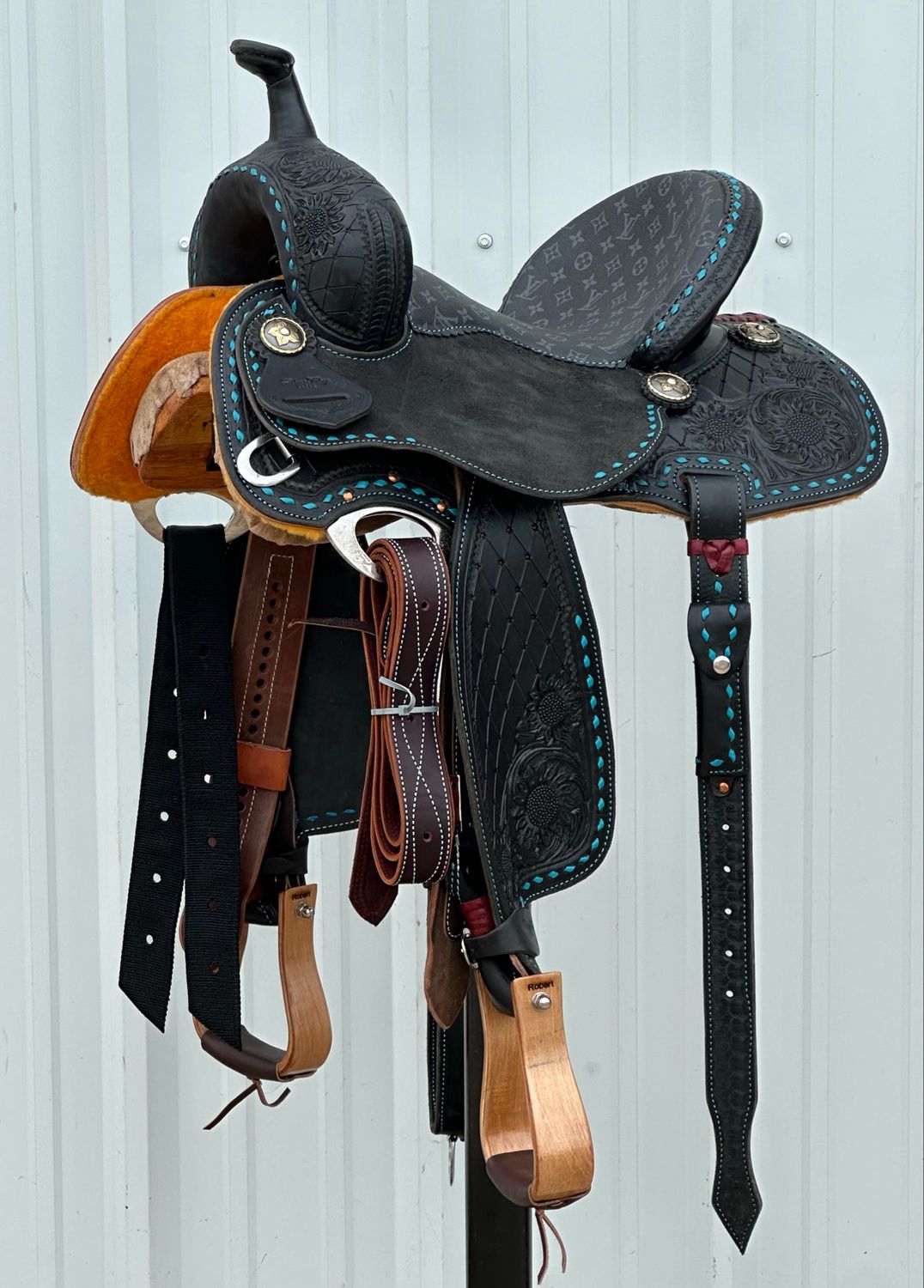 Robert Teskey Elite Barrel Racing Saddle with a 13 1/2- inch Padded Black Printed Canvas Seat Tooled Diamond Interlace with Sunflower Accent Turquoise Buck Stitch Dark Finish