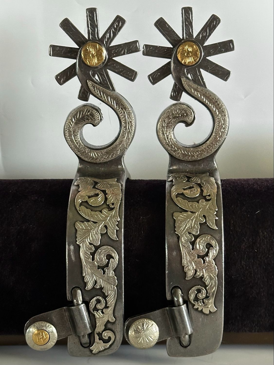 Men’s Western Spurs with a 1 1/4- inch Width Polished Steel Band with GS Trim and S- Shaped 3- inch Length Shanks with GS Trim and Gold Tone Dot and Engraved 9- Point Rowels 060926