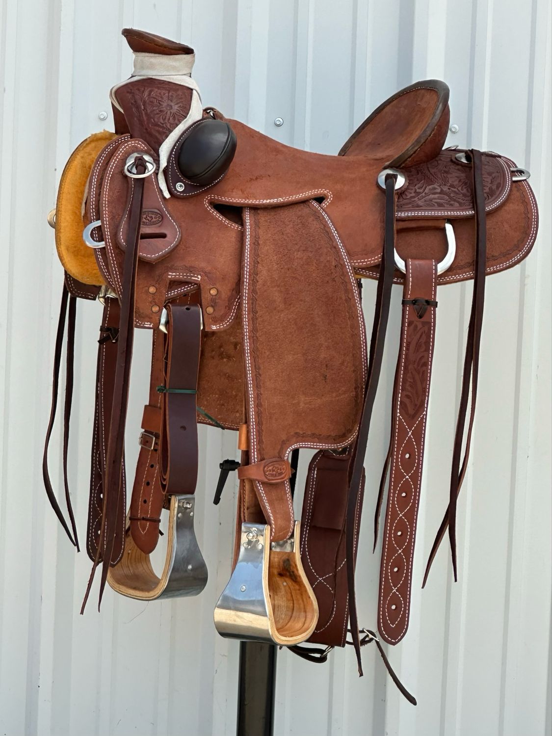 Heart O Texas Mule Seat Rig Saddle with a 15- inch Rough Out Seat Tooled Floral with Barbwire Border Dark Finish Bucking Rolls