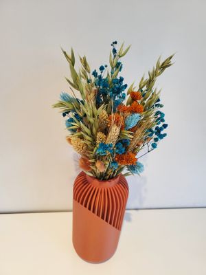 Moderne terracotta gekleurde vaas met droogbloemen