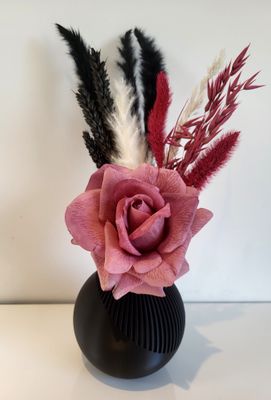 Gekleurd vaasje gevuld met zijdebloem en droogbloemen