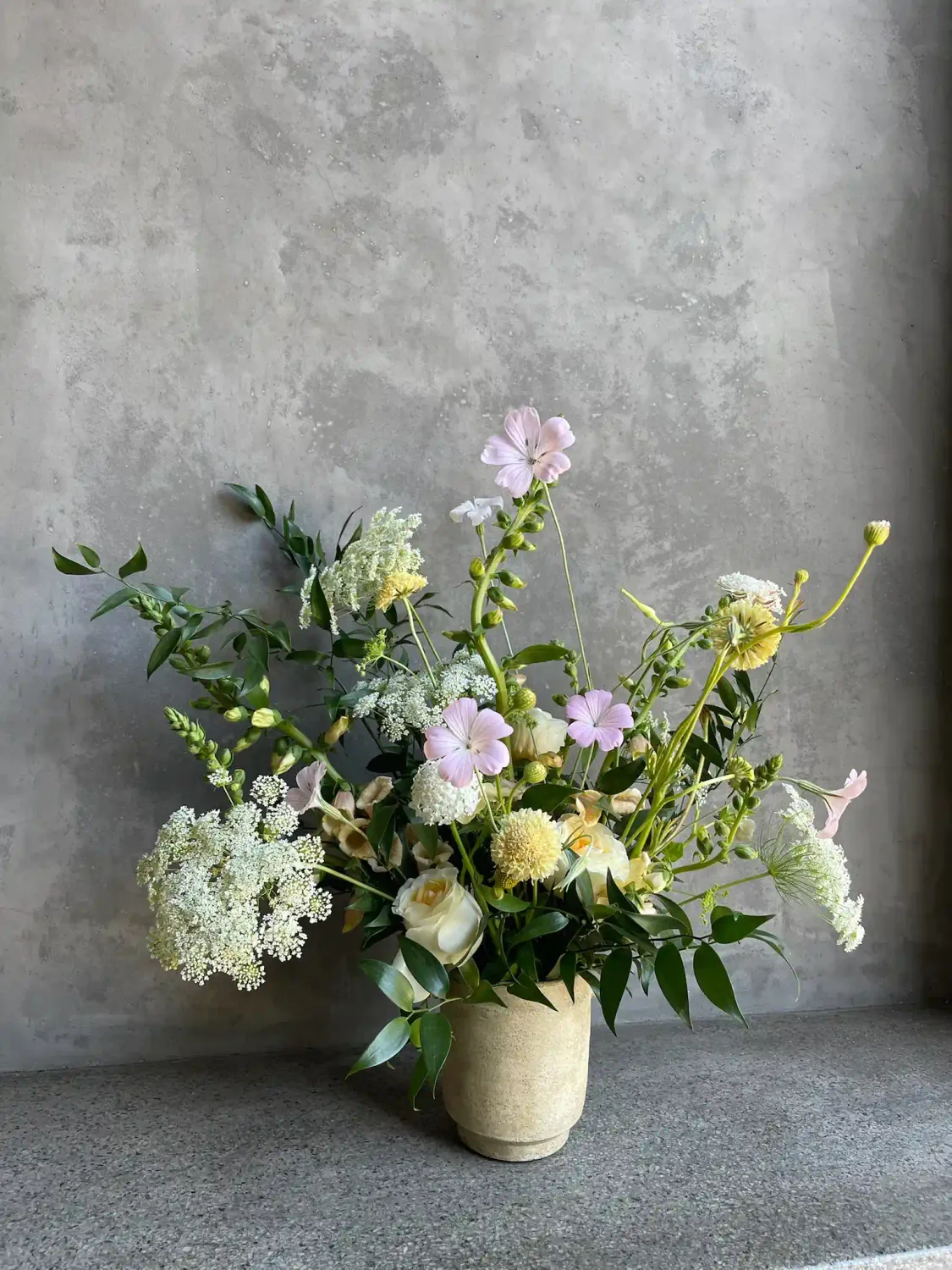 Wilder arrangement with lavender cosmos, yellow craspedia, Queen Anne's lace, and seasonal blooms in a wild airy style