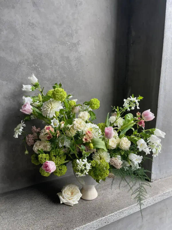 Sweetness arrangement featuring pink tulips, white dahlias, blush roses, and green viburnum in a lush garden style