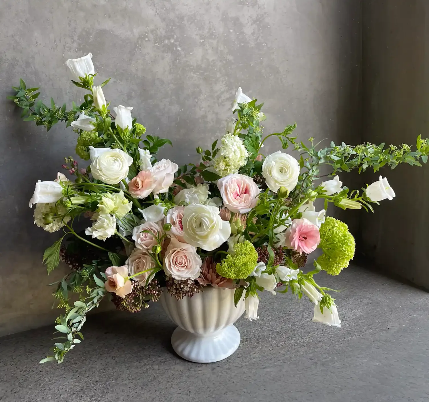 Sweetness arrangement with blush roses, white ranunculus, campanula, and green viburnum Le Bouquet San Francisco