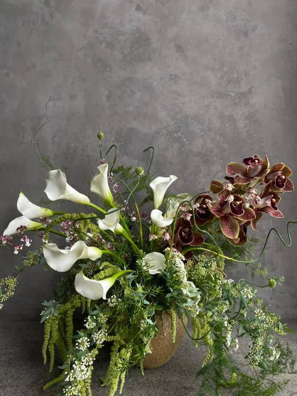 Block Buster arrangement with white calla lilies and burgundy orchids in ceramic vase San Francisco