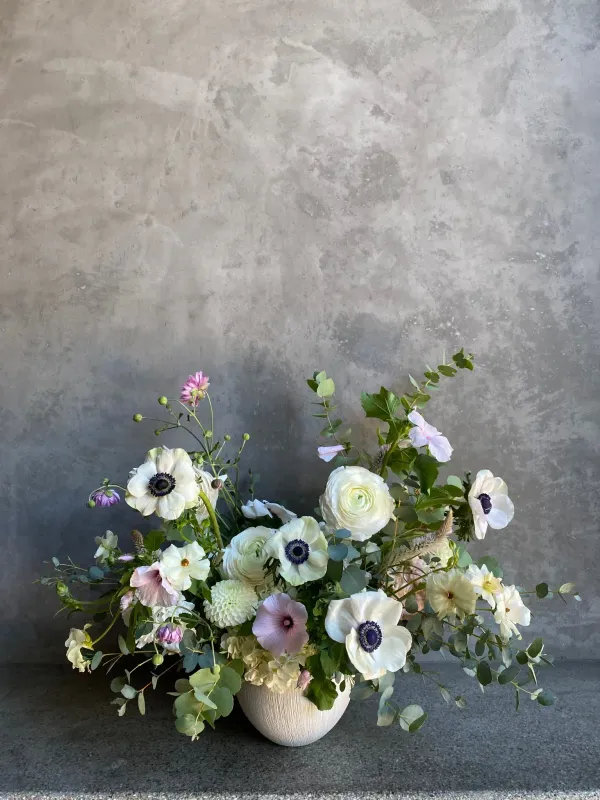 Anemone Garden arrangement with white anemones ranunculus and sweet peas in ceramic vase San Francisco