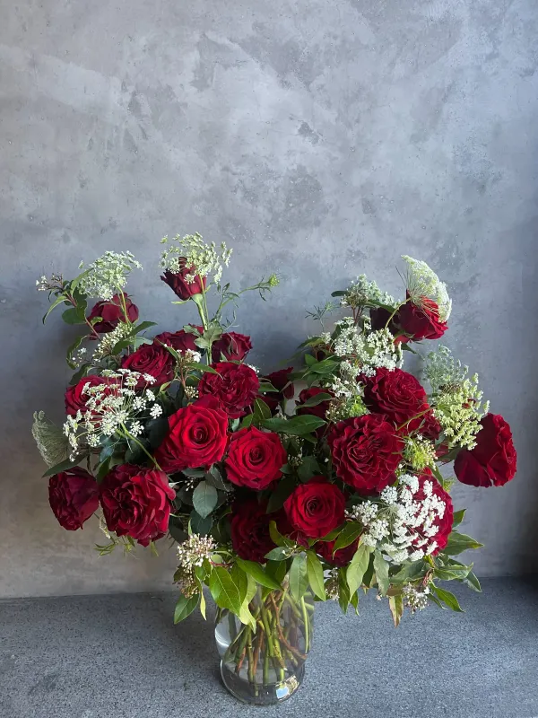 Three dozen Valentine's Day red roses with eucalyptus in glass vase San Francisco delivery