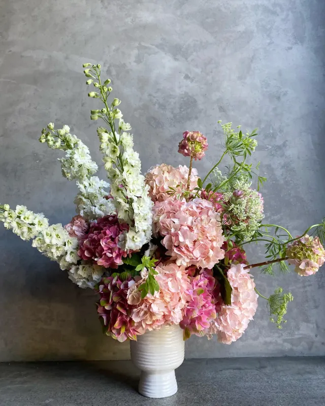 One and Only Valentine's arrangement with pink hydrangeas garden roses and white delphinium in ceramic vase San Francisco
