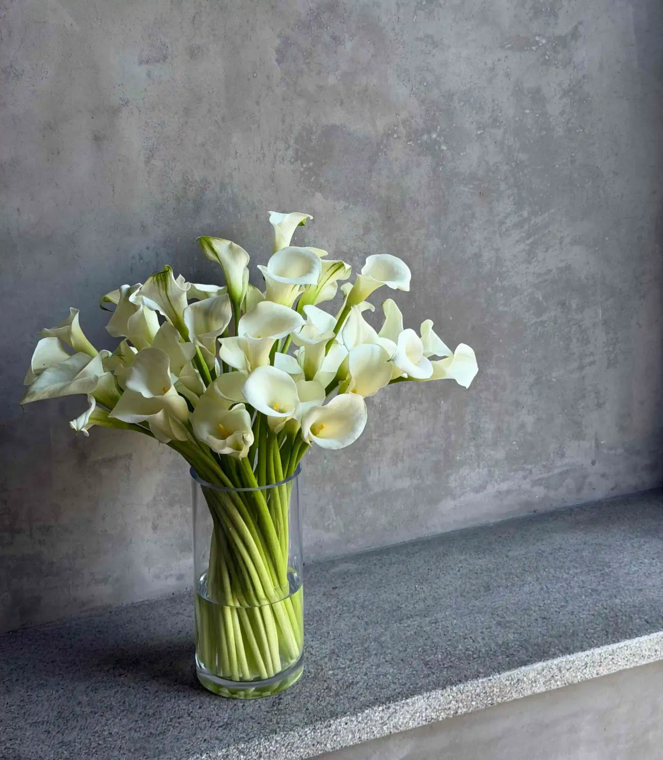 Abundant white calla lily Mother's Day bouquet in a glass vase by Le Bouquet San Francisco