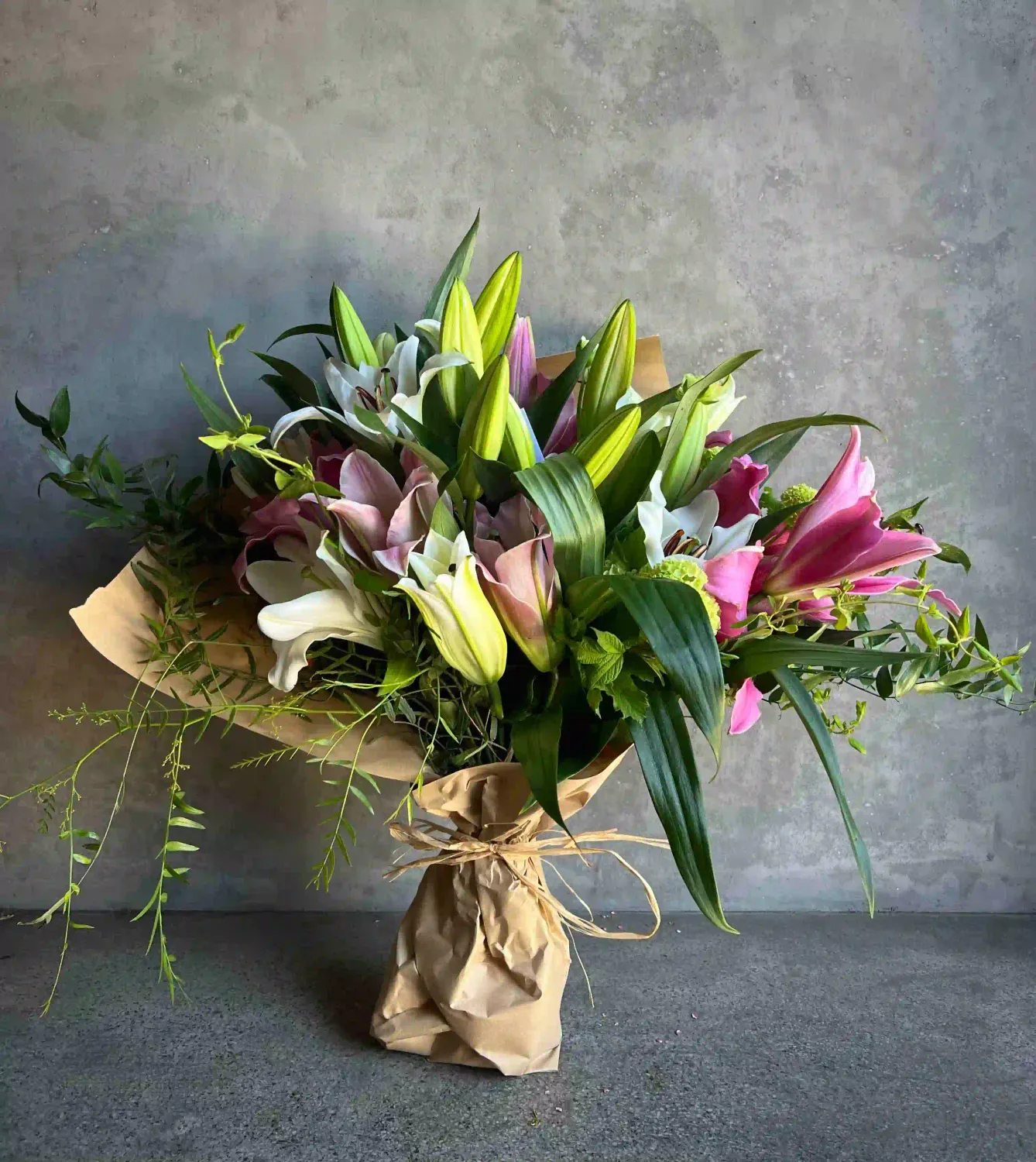 Abundant Mother's Day lily bouquet with pink and white oriental lilies wrapped in kraft paper by Le Bouquet San Francisco