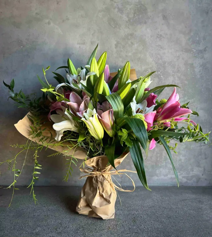Abundant Mother's Day lily bouquet with pink and white oriental lilies wrapped in kraft paper by Le Bouquet San Francisco
