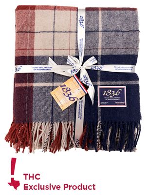 Direct photo of folded blanket showcasing pattern and packaging with THC Exclusive Product icon