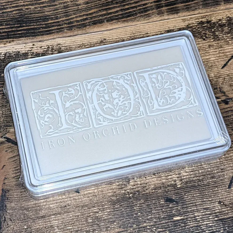 Clear plastic case with "IOD IRON ORCHID DESIGNS" logo, white letters on a light gray background.