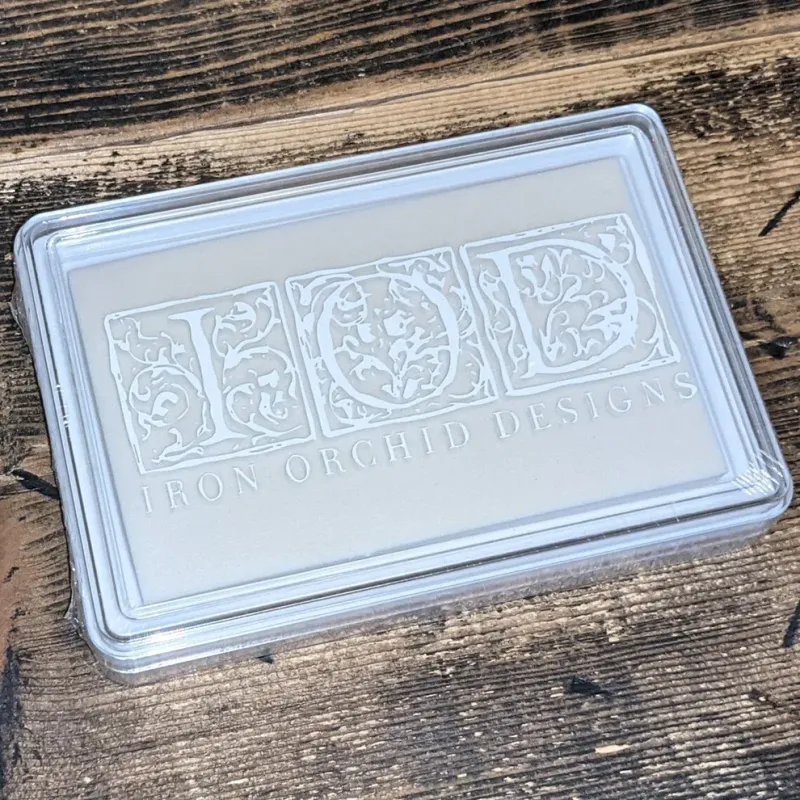 Clear plastic case with "IOD IRON ORCHID DESIGNS" logo, white letters on a light gray background.