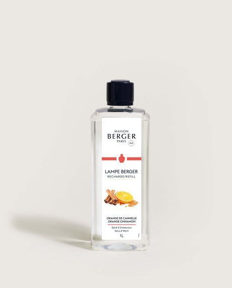 Bottle of Maison Berger lamp fragrance, featuring a label with a fruit and spice illustration.