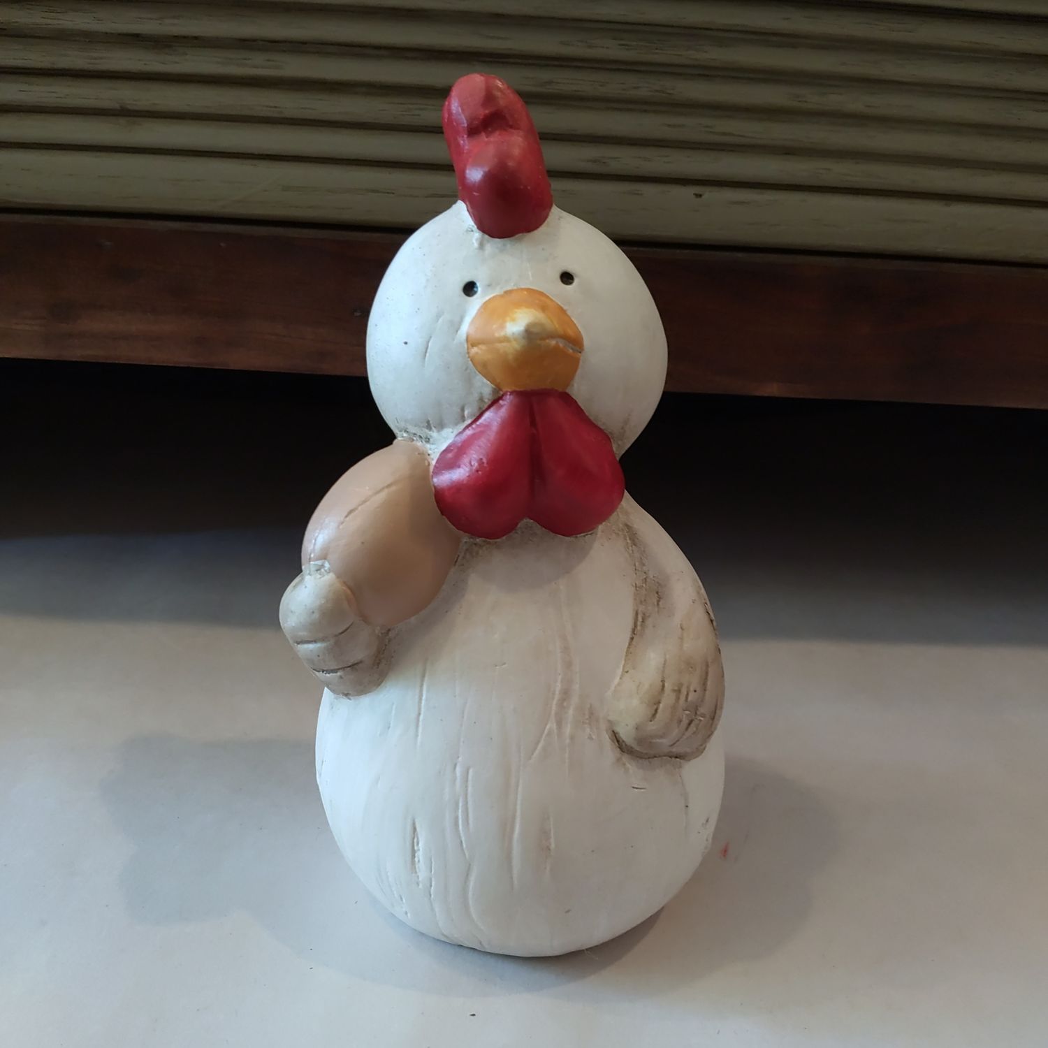 Chicken Holding Egg