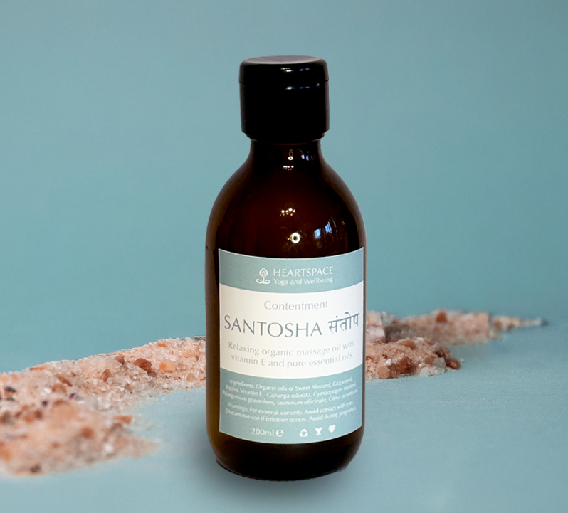 Product shot of HeartSpace 'Santosha' massage oil in 300ml amber glass bottle and flip cap lid. 