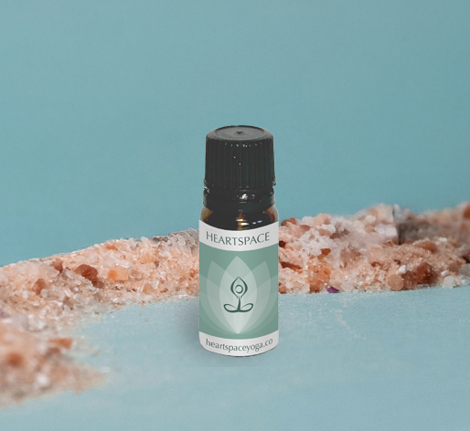 Product shot of HeartSpace essential oil in 10ml amber bottle with black cap. 