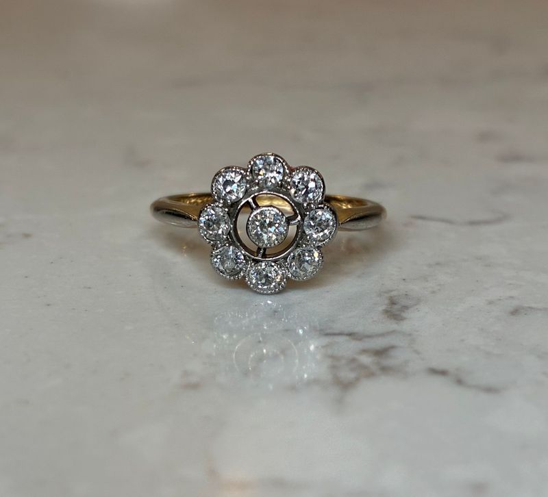 Edwardian 18ct gold and platinum openwork diamond daisy ring