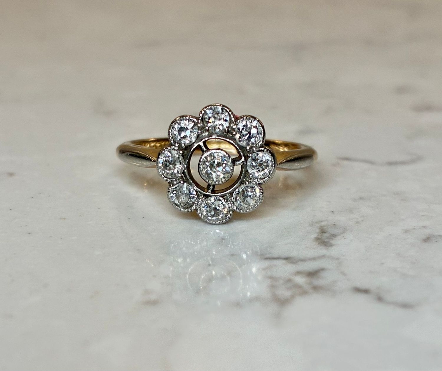 Edwardian 18ct gold and platinum openwork diamond daisy ring