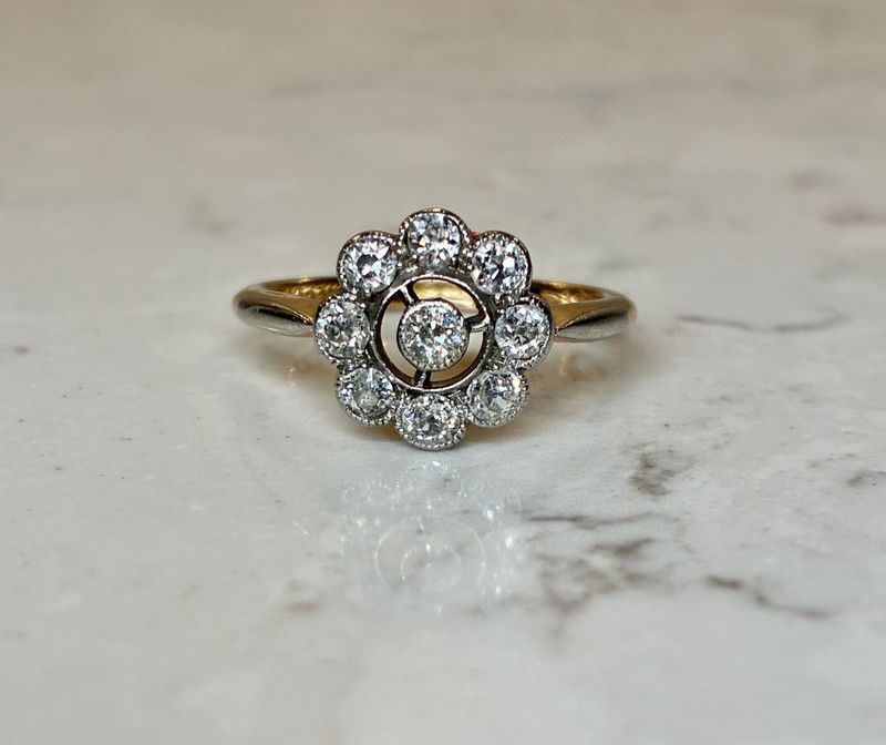 Edwardian 18ct gold and platinum openwork diamond daisy ring