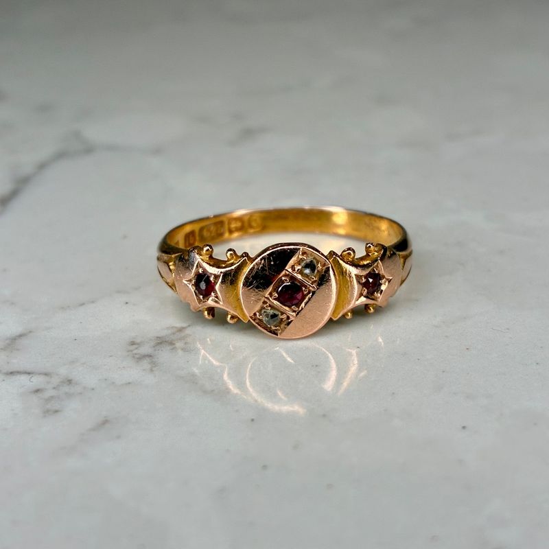Edwardian 15ct yellow gold garnet ring with diamond accents