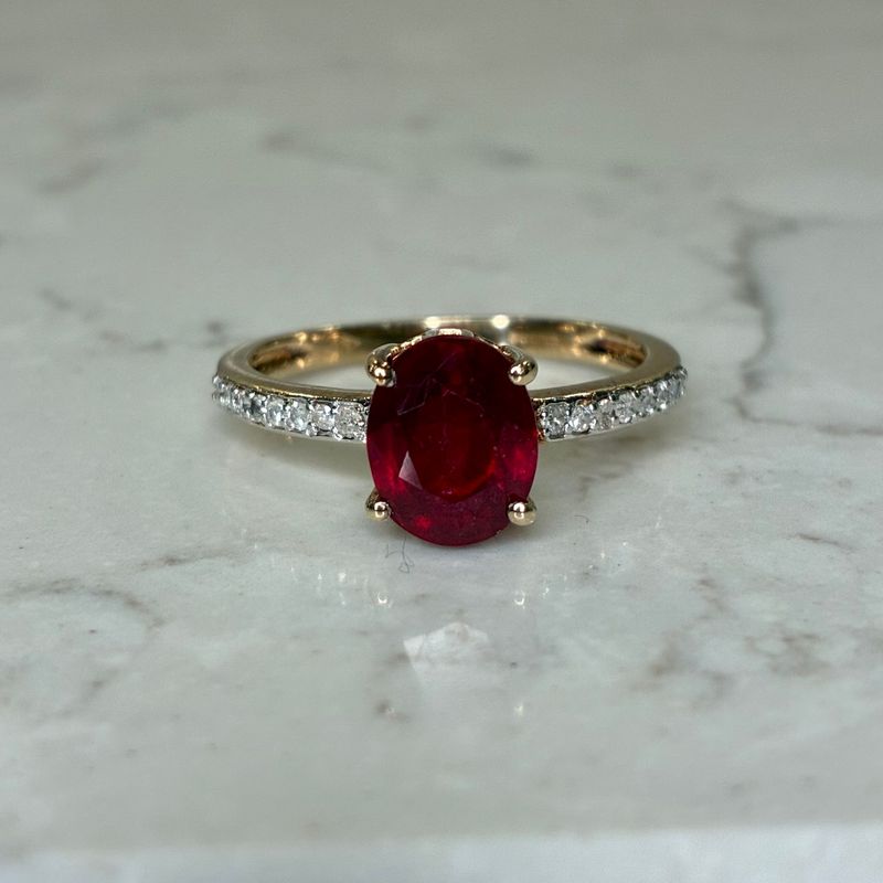 Vintage 9ct yellow gold ruby solitaire with diamond shoulders