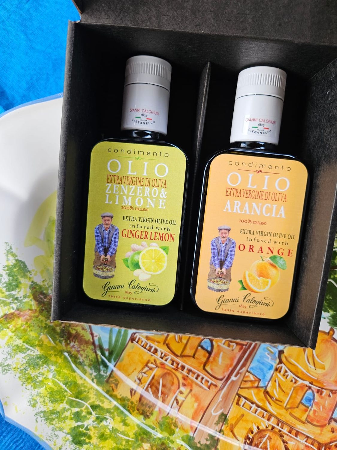 Appelsiini-oliiviöljy ja inkivääri-sitruuna-oliiviöljy setti CALOGIURI 2 x 250 ml (mustassa laatikossa)