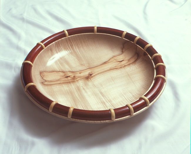 Sycamore platter with raised half pipe edge detail in padauk and semi random raised discs of lemonwood. 400mm diameter x 50mm. COMMISSION ONLY AT PRESENT. Please contact the office Sycamore platter with raised half pipe edge detail in padauk and semi random raised discs of lemonwood. 400mm diameter x 50mm. COMMISSION ONLY AT PRESENT. Please contact the office