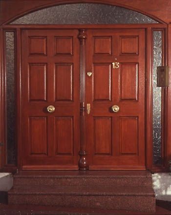Double entrance door set with turned column at meeting edge. COMMISSION ONLY