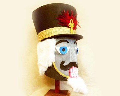Nutcracker head black hat, white hair.