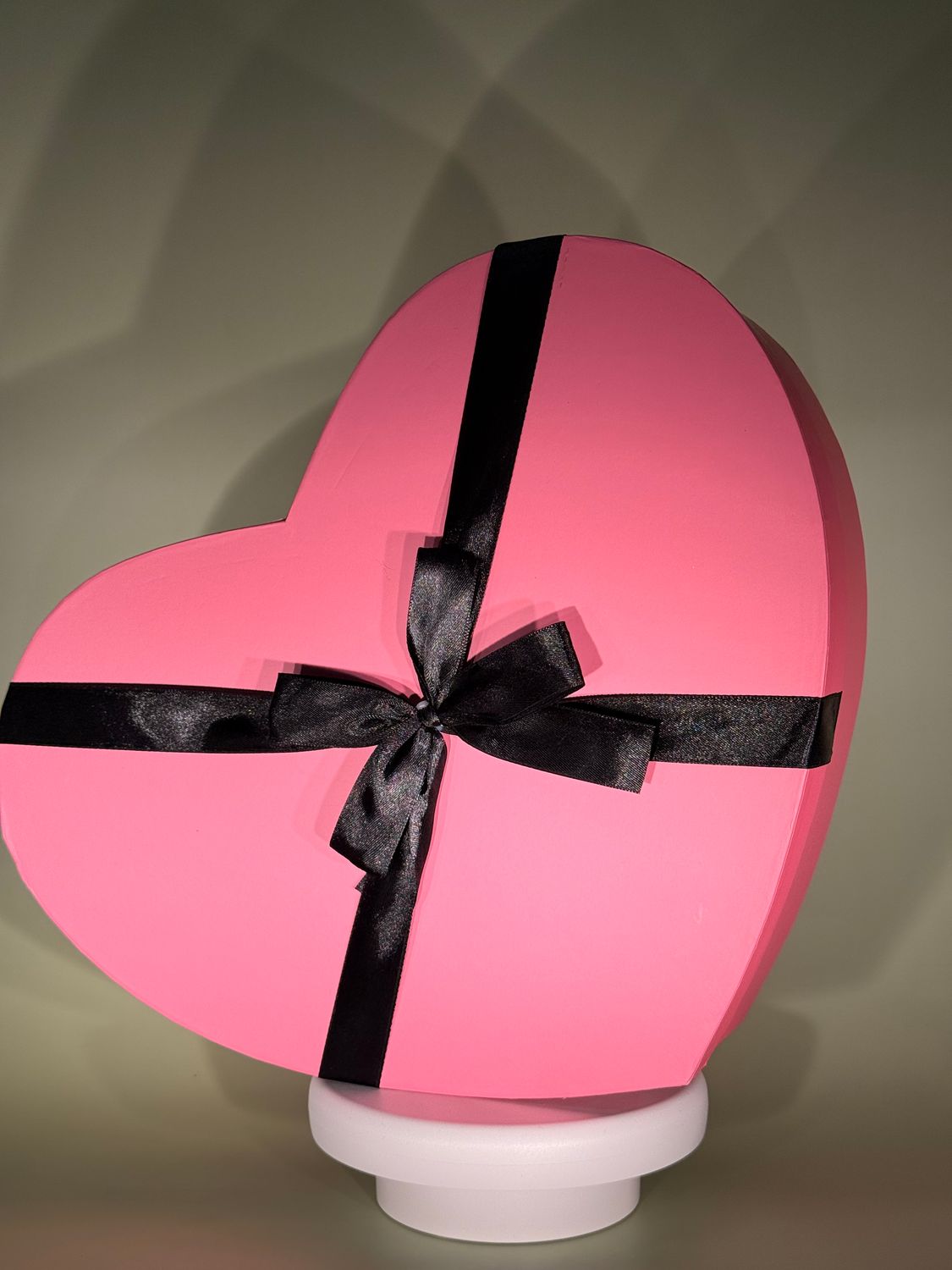 Różowe pudełko w kształcie serca z wstążką