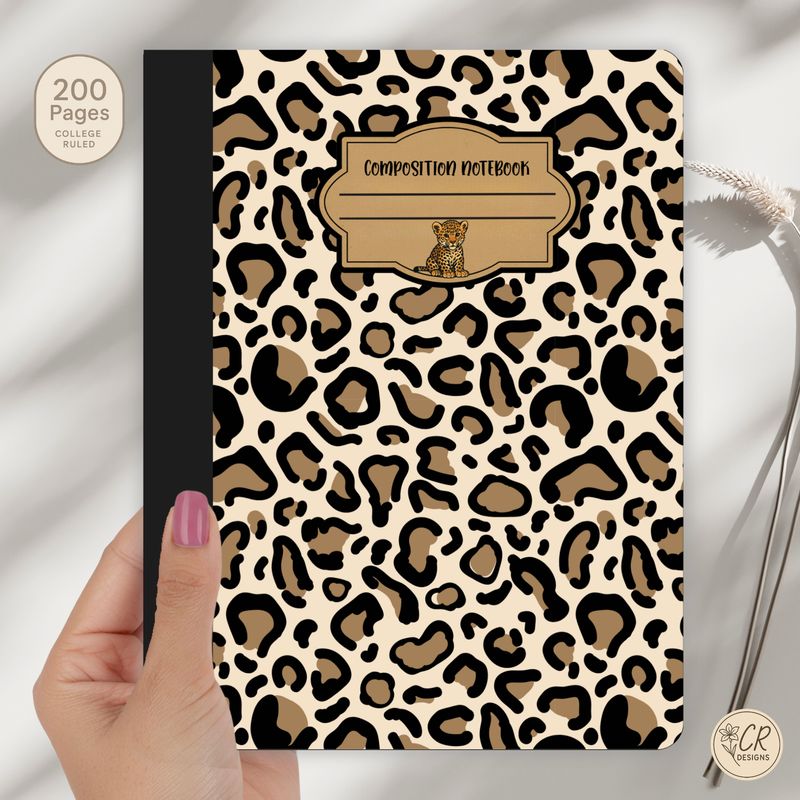 Leopard print composition notebook with a beige and black animal pattern, black spine, and a vintage-style label featuring a 