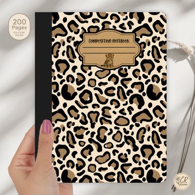 Leopard print composition notebook with a beige and black animal pattern, black spine, and a vintage-style label featuring a 