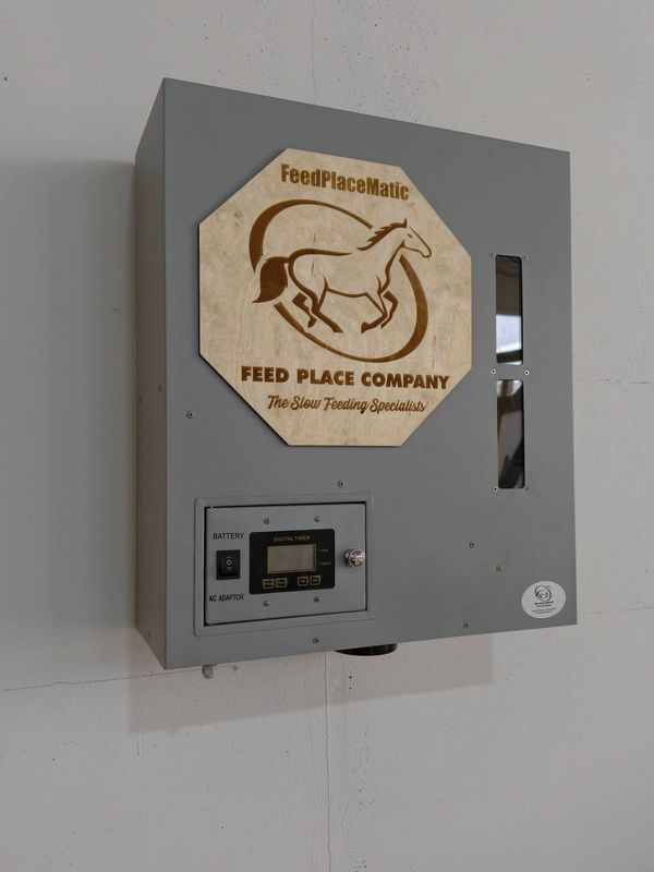 FeedPlaceMatic horse feeder by FEED PLACE COMPANY, gray metal box with digital display and battery …