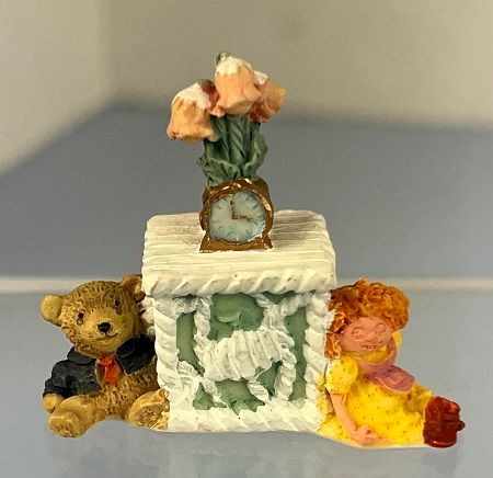 1/24th Resin Table with Clock, Flowers, Two Toys