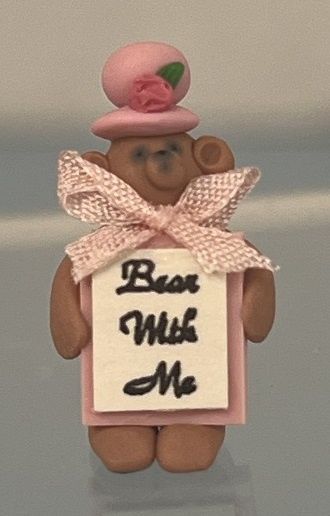 Brown Bear Wearing Pink Hat Holding 'Bear with Me' Sign Beary1J
