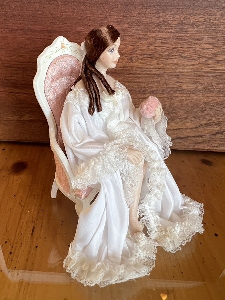 Lady in a white dressing gown with powder puff in hand ala266