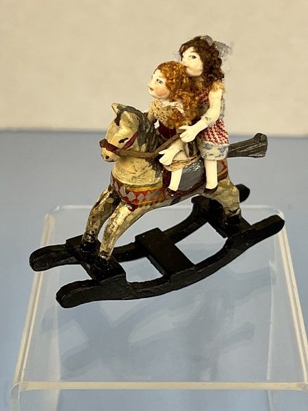Two Sisters Riding on a Rocking Horse mc04129