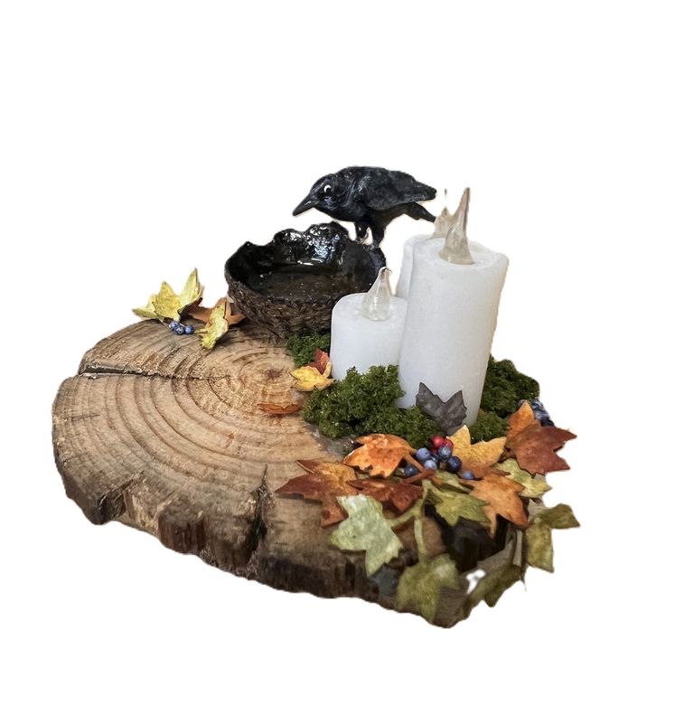 Three Candles, Water Bowl, and Crow on Cedar Table